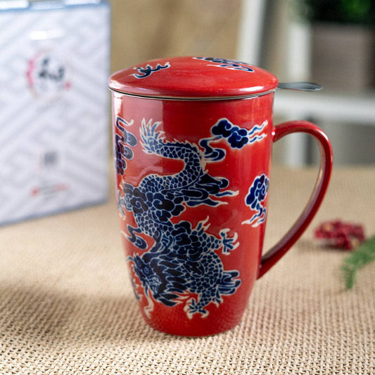 Red mug with blue dragon design on a textured surface
