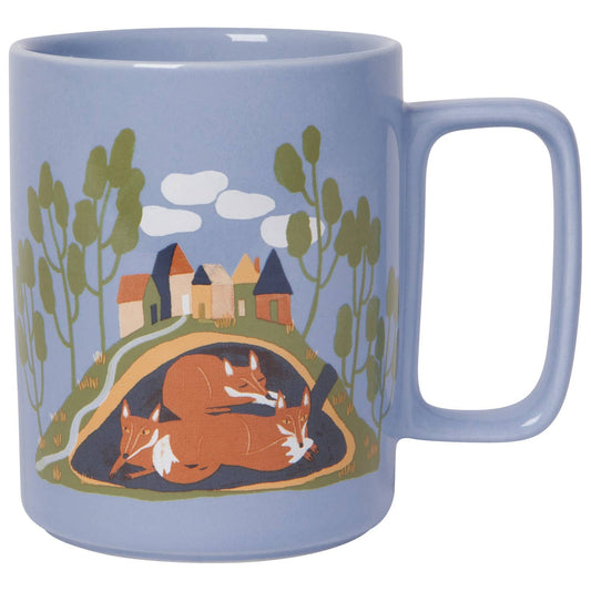 Blue mug with fox and village design on a white background
