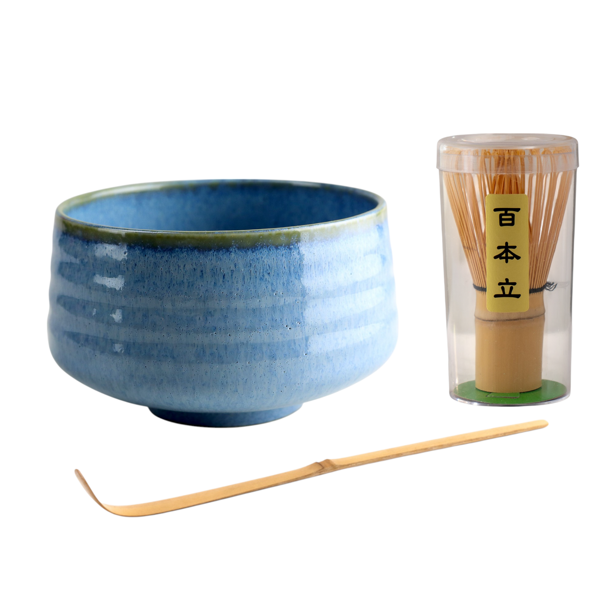 Blue ceramic bowl with wooden whisk and container on a white background
