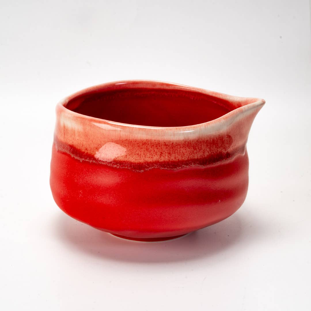 Red ceramic bowl with a smooth surface on a white background
