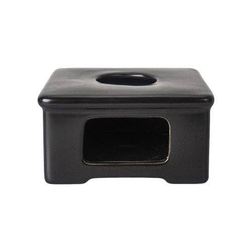 Black square-shaped object with a circular indentation on a white background
