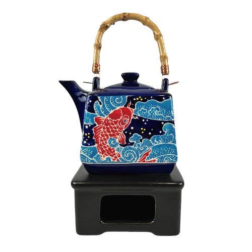 Decorative teapot with Koi fish design on a white background