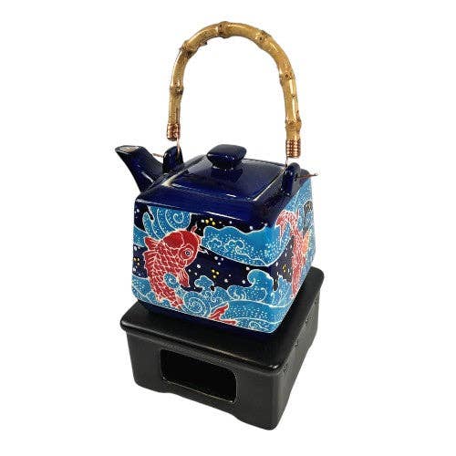 Ceramic teapot with Koi fish design on a white background